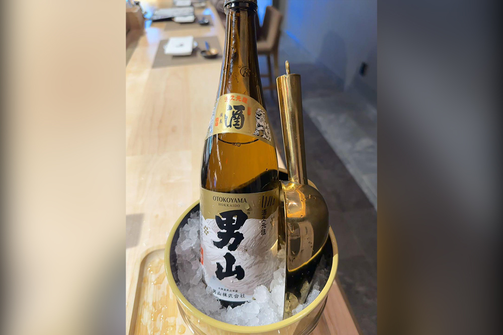Chilled Otokoyama sake bottle in an ice bucket