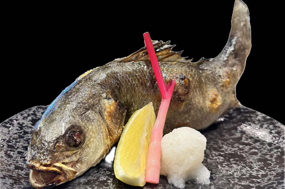 Whole grilled fish with lemon daikon and pickled garnish